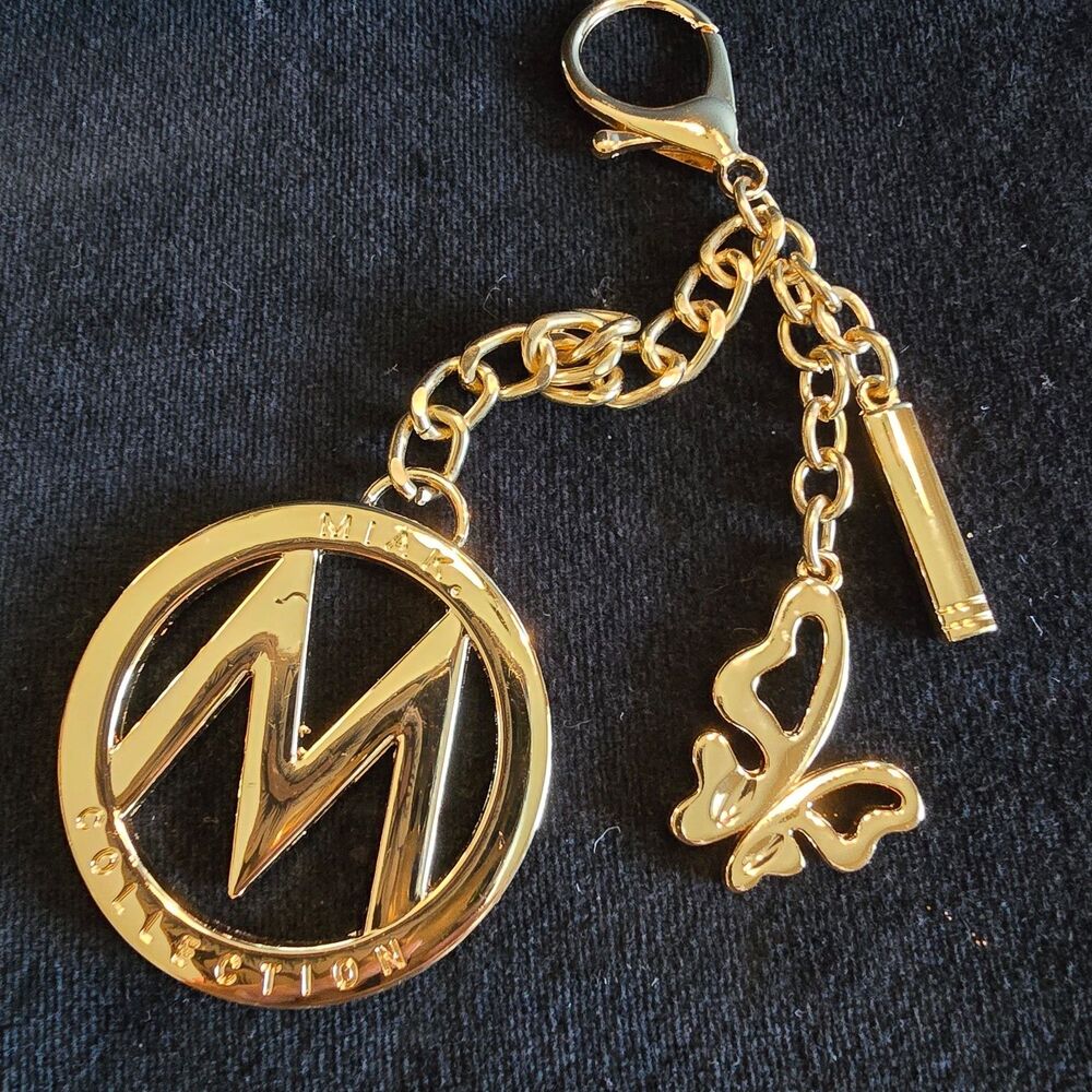 MIAK COLLECTION Gold Tone M Logo Keychain with Butterfly Charm preowned